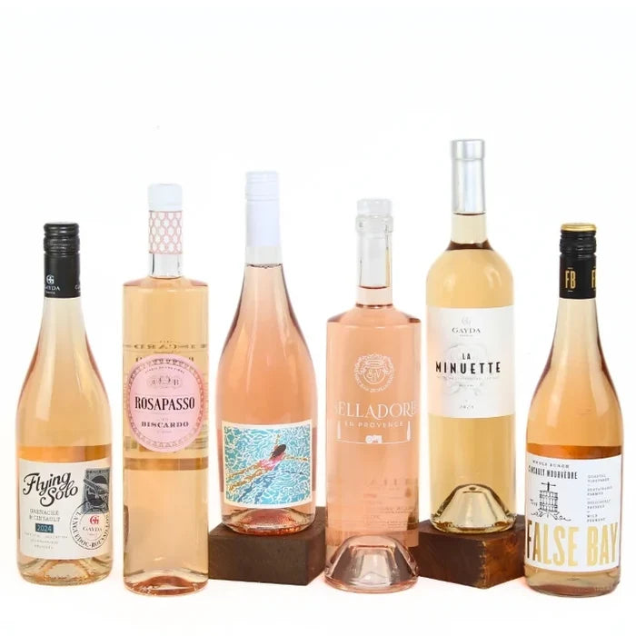 Collection of six bottles of rosé wine with various labels on a white background